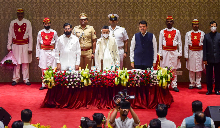 Newly Elected Maharashtra Chief Minister Eknath Shinde(L) and Deputy Chief Minister Devendra Fadnavis with Governor Bhagat Singh Koshyari(C) during their oath-taking ceremony at Raj Bhavan | PTI