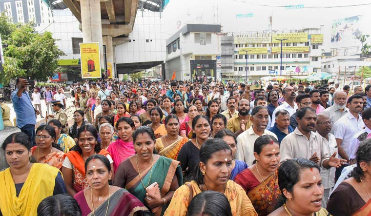 Devotees stage road blockade in Kochi over Supreme Court's verdict allowing women of all ages to enter Sabarimala temple | PTI