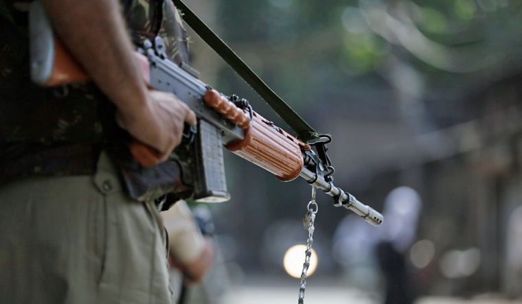 [File] A paramilitary official standing guard in Srinagar | AP