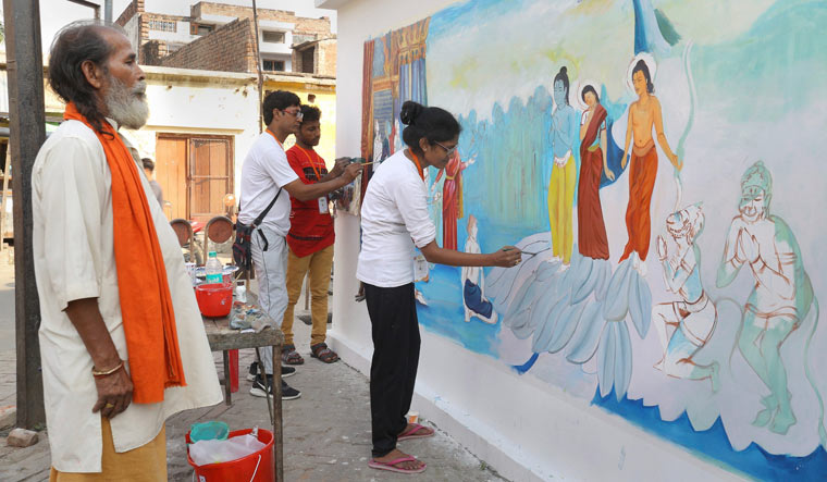 Artists make a wall graffiti on the life of Lord Rama, ahead of Ram Navami festival in Ayodhya on Saturday | PTI