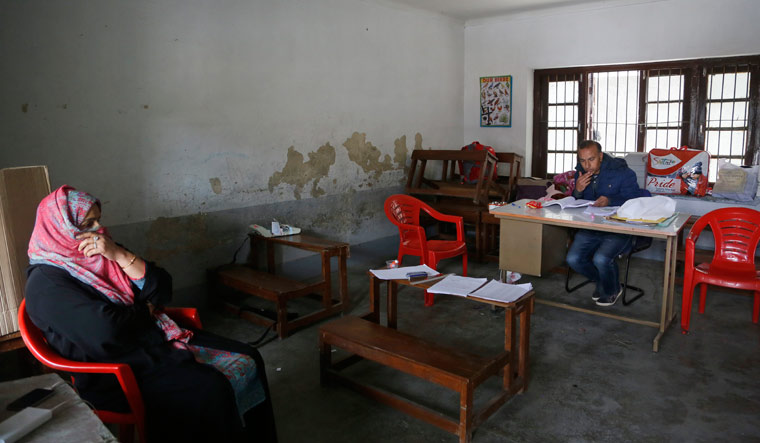Polling officers sit inside a polling station during the fourth phase of local elections in Srinagar | AP