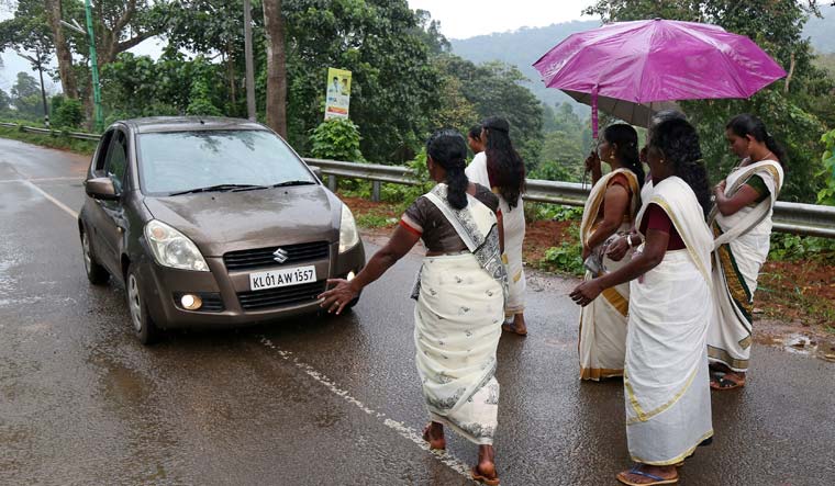 Women devotees stop a car to check if any young women are headed towards the Sabarimala temple at Nilakkal | Reuters
