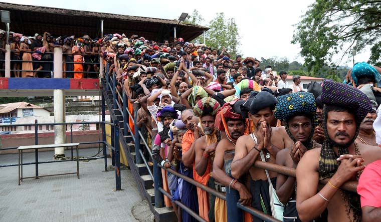 Devotees wait in queues inside the premises of the Sabarimala temple | Reuters