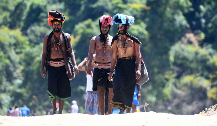 Devotees walk to vist Lord Ayyappa temple in Sabarimala | AFP