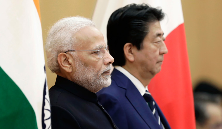 Prime Minister Narendra Modi and Japan's Prime Minister Shinzo Abe observe an honour guard ahead of a meeting at Abe's official residence in Tokyo | AP
