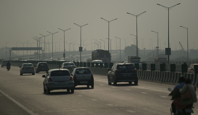 Commuters travel along a highway amidst heavy smog in New Delhi | AFP