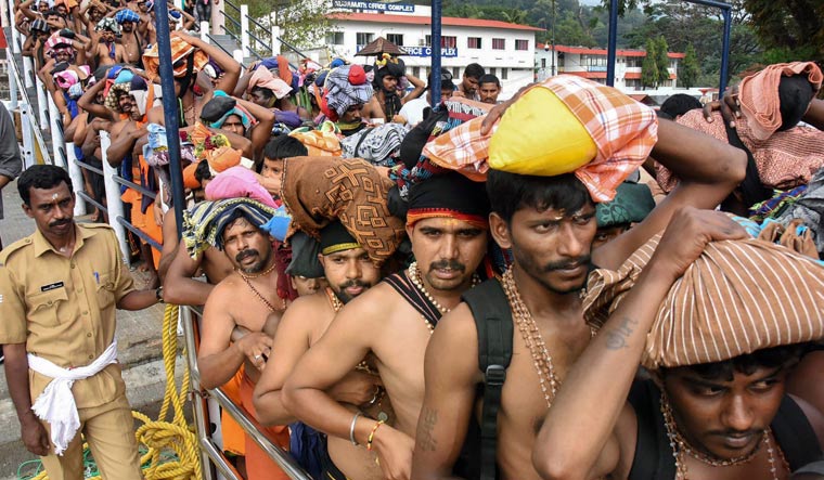  Devotees queue up to offer prayers at Lord Ayyappa temple in Sabarimala | PTI