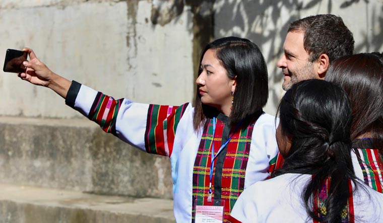 Congress President Rahul Gandhi obliges his supporters for selfies during an election rally in Champai, Mizoram on November 20 | PTI