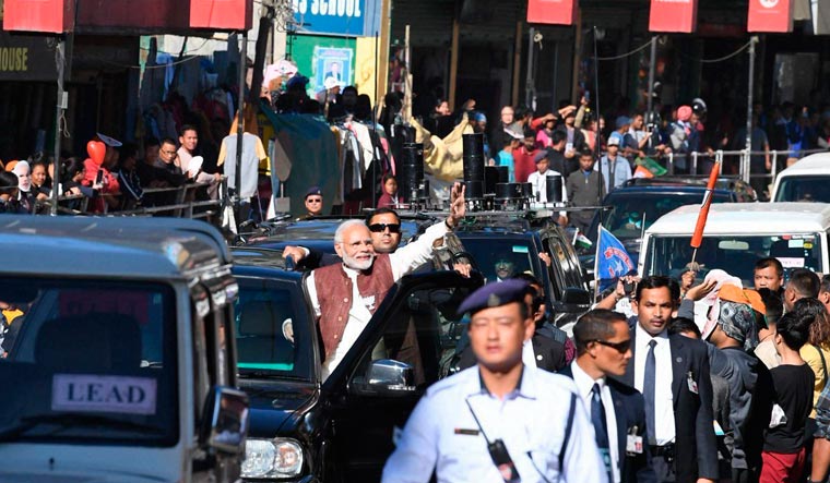 [File]  Prime Minister Narendra Modi waves during an election roadshow in Aizawl, Mizoram on November 23 | PTI