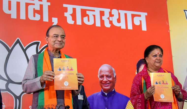 Union minister Arun Jaitley along with Rajasthan Chief Minister Vasundhara Raje releases the BJP manifesto for the assembly elections, in Jaipur | PTI