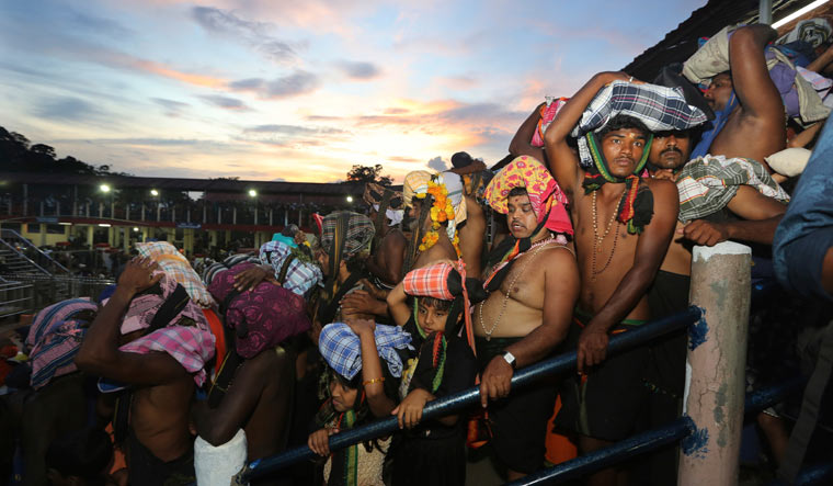Devotees carrying customary offerings on their heads, wait to worship at the Sabarimala temple on November 5 | AP