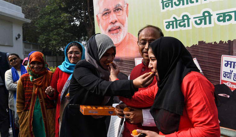 Muslim women celebrate the passing of triple talaq bill in Lok Sabha, in New Delhi on December 27 | AFP