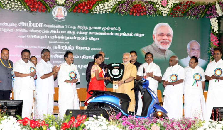 Prime minister Narendra Modi launching the Tamil Nadu government's Amma scooter scheme for working women by handing over a vehicle to a beneficiary in Chennai