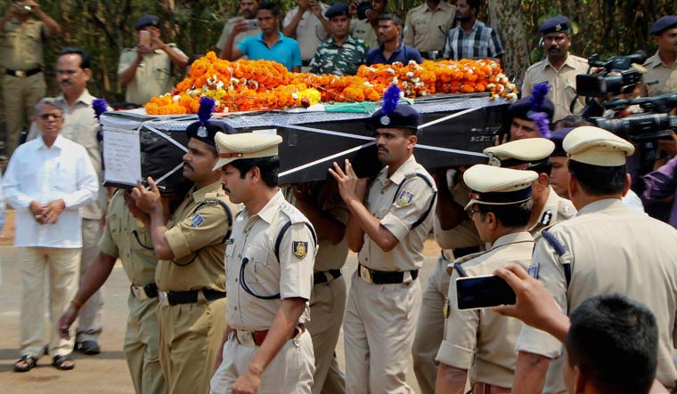 CRPF personnel carry a coffin containing the mortal remains of CRPF constable Manoranjan Lenka