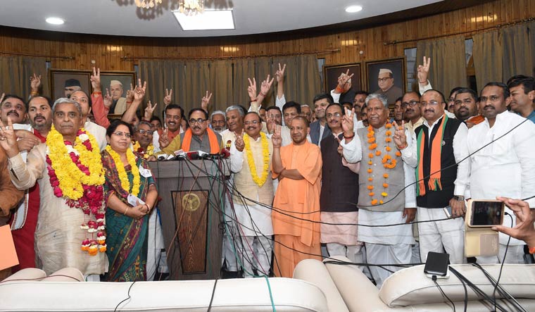 Uttar Pradesh Chief Minister Yogi Adityanath flashes the victory sign with newly elected BJP MP's of Rajya Sabha in Lucknow | PTI