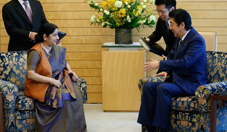 Foreign Minister Sushma Swaraj talks with Japan's Prime Minister Shinzo Abe at latter's official residence in Tokyo | AFP