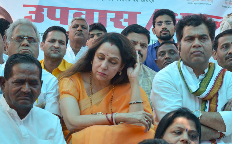 BJP MP Hemamalini, along with Uttar Pradesh minister Srikant Sharma, sitting on fast in protest against the stalling of parliament proceedings by the opposition, in Mathura | PTI