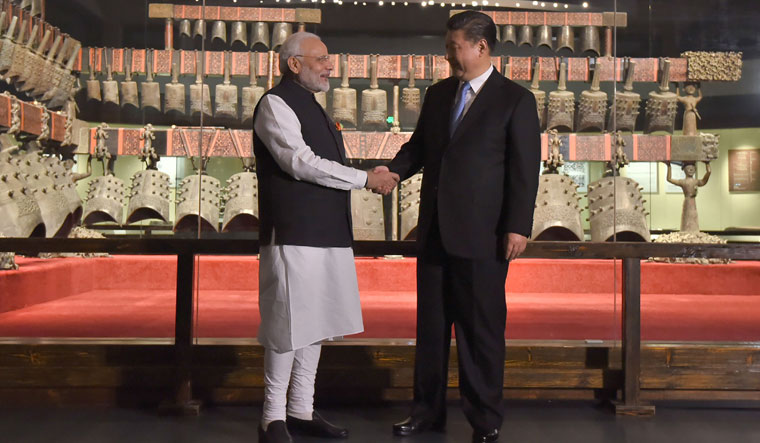 Prime Minister Narendra Modi shaking hands with Chinese President Xi Jinping at Hubei Provincial Museum, in Wuhan | AFP