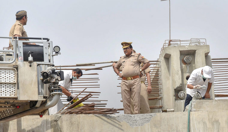 Forensic experts examine the flyover-collapse site in Varanasi on Wednesday, a day after the mishap | PTI