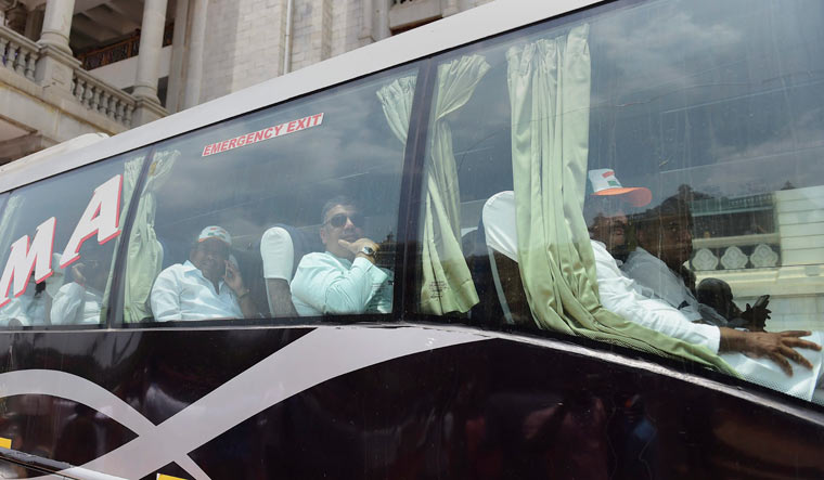 Congress MLAs, sitting in a bus, leave the Vidhana Soudha after staging a protest dharna against the swearing-in of B.S. Yeddyurappa as Karnataka chief minister, in Bengaluru on Thursday | PTI