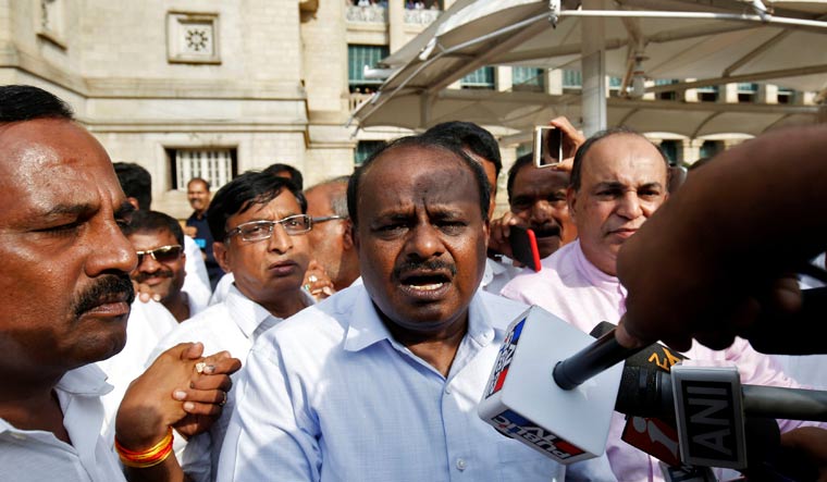 Kumaraswamy speaks to the media outside the legislative house | Reuters