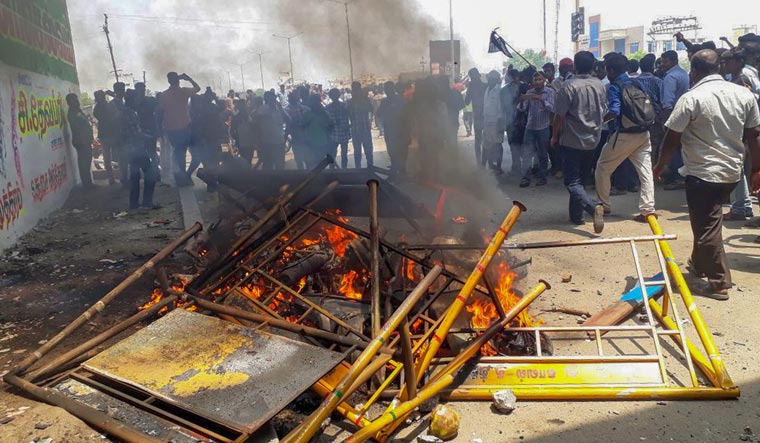 Smoke billows from burning barricades as agitators march through streets demanding the closure of Vedanta's Sterlite Copper unit in Thoothukudi on Tuesday | PTI