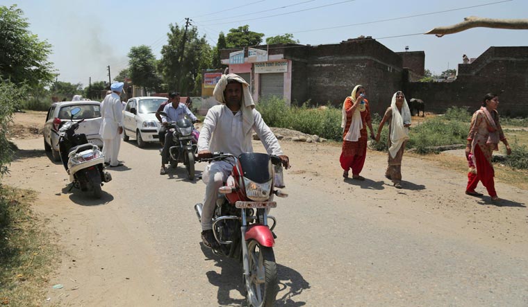 Villagers move to a safer area following firing from the Pakistan side of the border at Bainglad village in Samba sector | AP