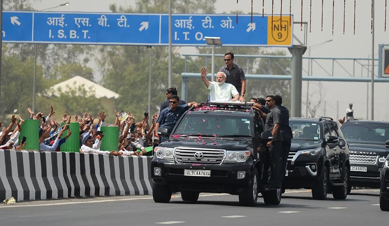 Prime Minister Narendra Modi waves to supporters during a road-show after inaugurating the Delhi-Meerut expressway | PTI