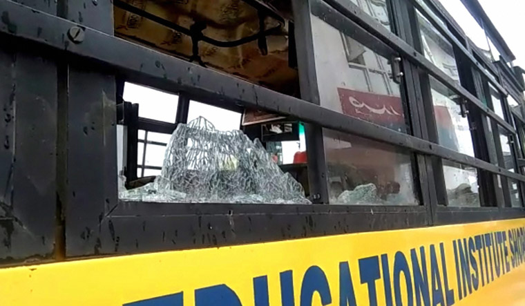 The damaged school bus which was attacked by stone-pelters at Zavoora area in Shopian | PTI
