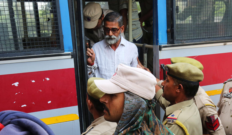 [File] Sanji Ram, one of the eight accused in the rape and murder of an eight-year-old girl in Kathua, arrives for a court appearance in Pathankot | Reuters