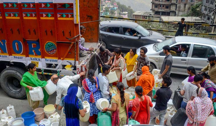 People gather around a truck to collect water in Shimla | PTI
