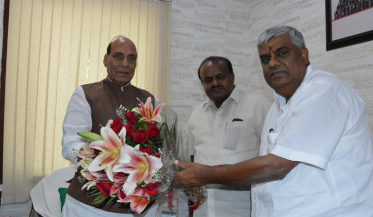 Karnataka Chief Minister H.D. Kumaraswamy and his brother H.D.  Revanna greeting Union Home Minister Rajnath Singh in Delhi on Monday 