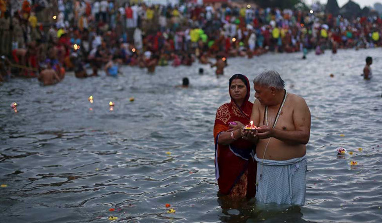 [File] A couple praying during the Kumbh Mela | Reuters