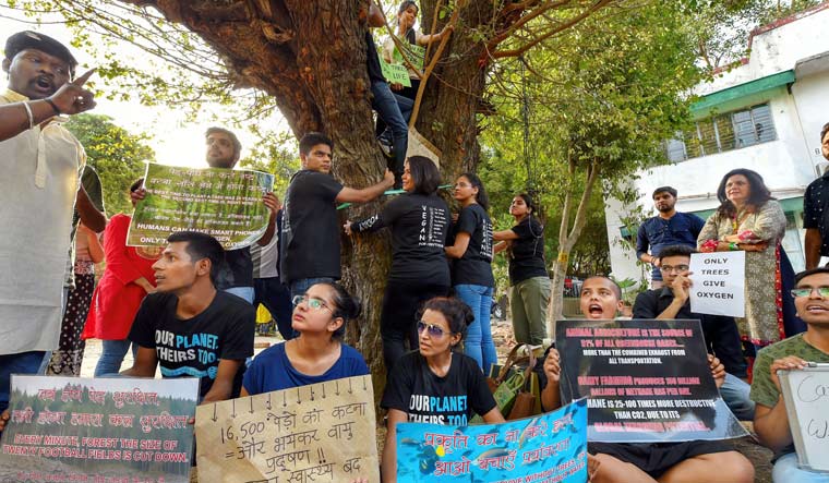 Activists from various environmental organisations display placards during a protest against cutting of trees in Delhi | PTI