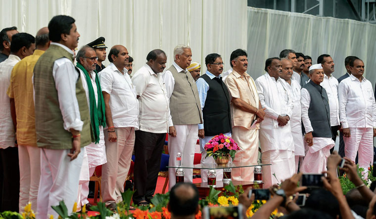 Karnataka Governor Vajubhai Vala, Chief Minister H.D. Kumaraswamy, Deputy Chief Minister G. Parameshwara with newly inducted ministers during the first expansion of the JD(S) and Congress coalition government, at Rajbhavan in Bengaluru on Wednesday | PTI
