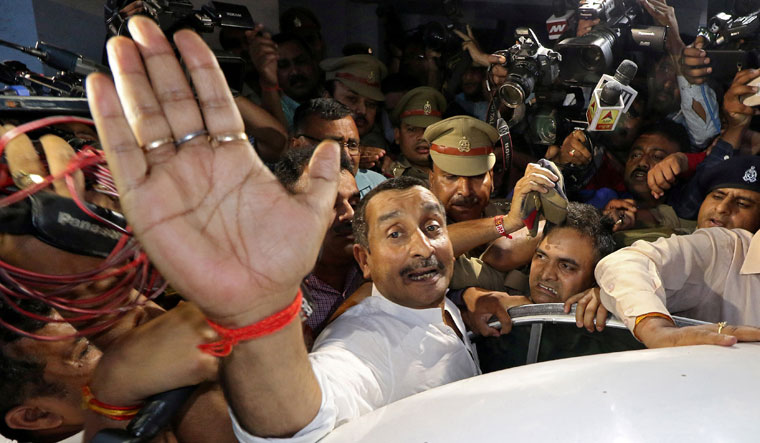 Kuldeep Singh Sengar reacts as he leaves a court after he was arrested in connection with the rape of a teenager in Lucknow on April 14 | Reuters