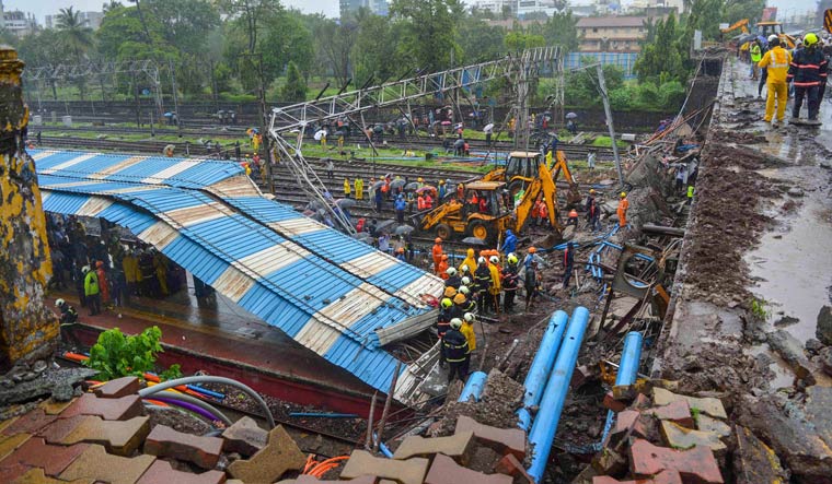 Rescue and relief work underway after a foot overbridge collapsed on the railway tracks following heavy rains, at Andheri Station in Mumbai | PTI