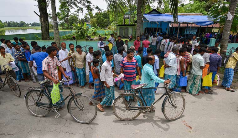 People wait to check their names on the final draft of Assam's National Register of Citizens after it was released, at an NRC Seva Kendra in Nagaon | PTI