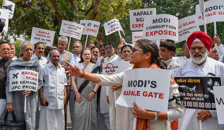 UPA chairperson Sonia Gandhi along with other opposition party leaders raise slogans during a protest against the Union government over Rafale deal issue, at Parliament House | PTI