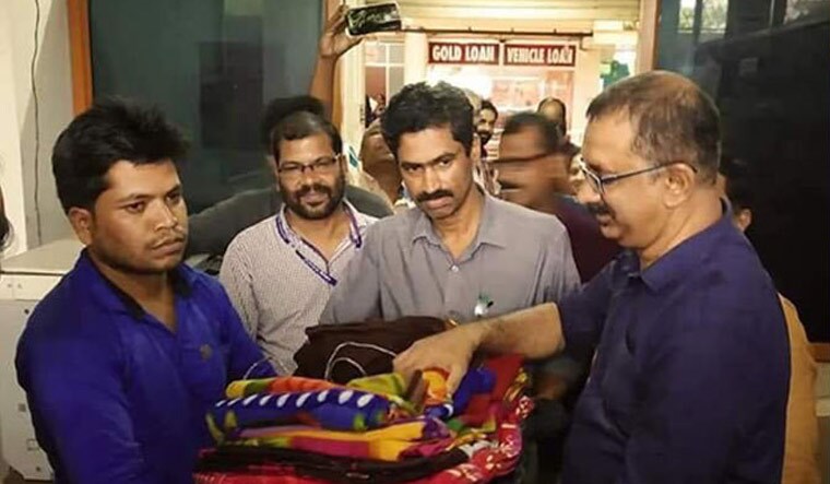 Vishnu hands over the blankets to Kannur collector Mir Mohammed Ali at the relief camp | Via Onmanorama