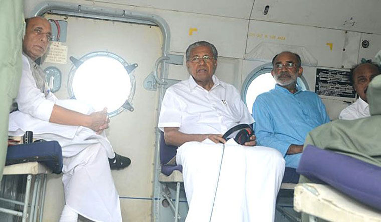 Union home minister Rajnath Singh, along with Chief Minister Pinarayi Vijayan and Union minister Alphons Kannanthanam, conducts an aerial survey of the flood-hit areas in Kerala | Manoramaonline