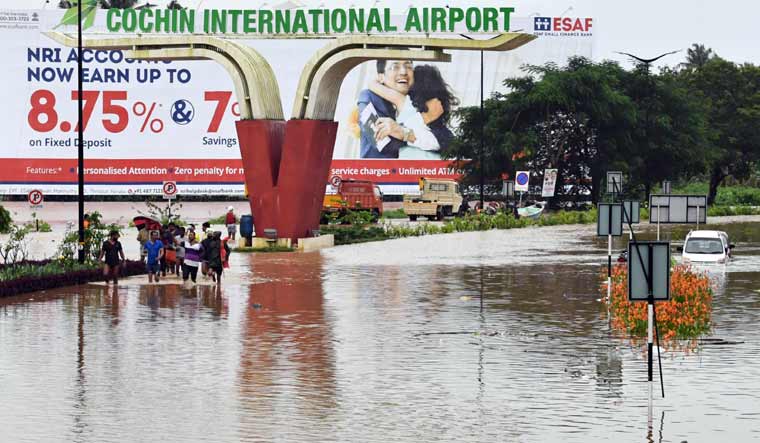 People wade through a flooded road leading to Cochin International Airport | Josekutty Panackal