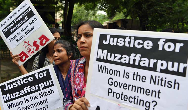 Activist hold placards as they take part in a protest over the sexual assault of girls at a state-run home in eastern India city, near Bihar Bhawan in New Delhi on July 30, 2018 | AFP 