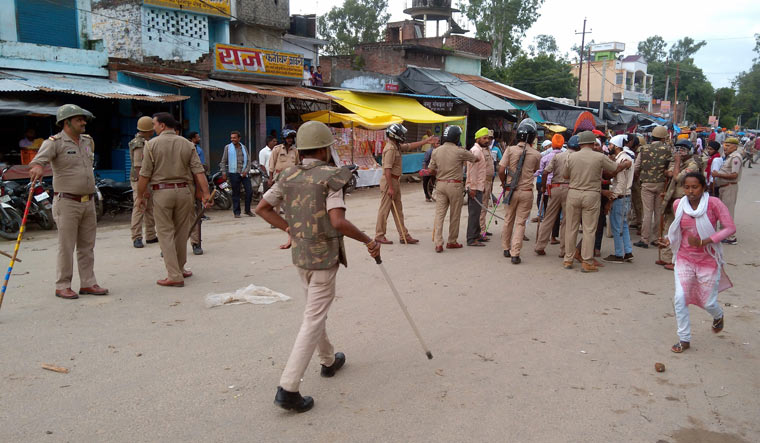 Policemen stand guard a street in Banda town of Shahjahanpur after tension on Saturday | PTI