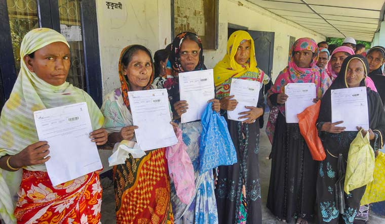 People queue to verify and check their names in the final draft of the National Register of Citizens, at Morigoan on August 4 | PTI