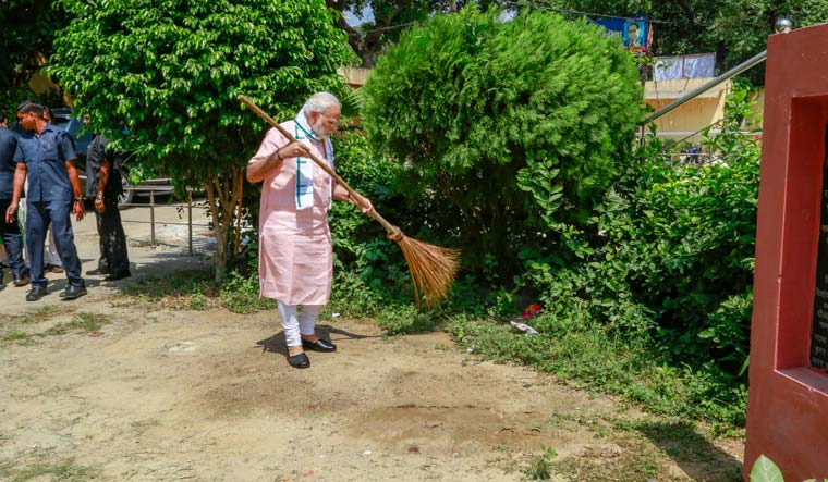 Prime Minister Narendra Modi undertakes a cleanliness drive under 'Swachhta Hi Sewa' campaign in the premises of Baba Sahib Ambedkar Higher Secondary School at Paharganj, in New Delhi on Saturday | PTI