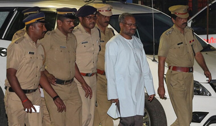 Bishop Franco Mulakkal, accused of raping a nun, is escorted by police outside a crime branch office in Kochi | Reuters