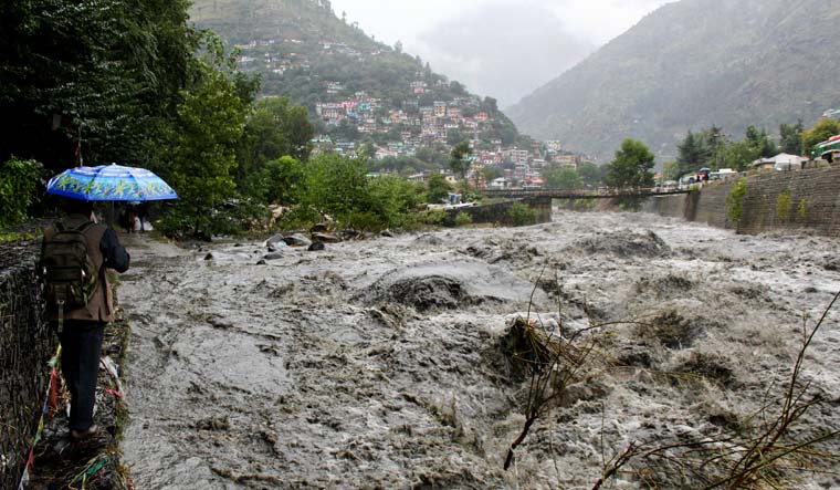 A man looks at a flooded Beas River following heavy rains in Kullu, Himachal Pradesh | AP