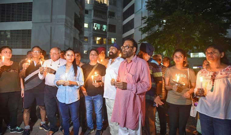 PMC depositors participate in a candlelight march for late Sanjay Gulati, at Andheri in Mumbai | PTI