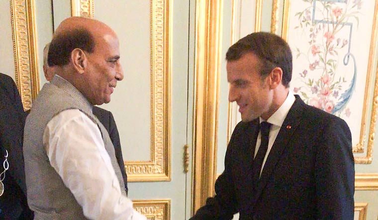 Union Defence Minister Rajnath Singh shakes hands with French President Emmanuel Macron in Paris | PTI